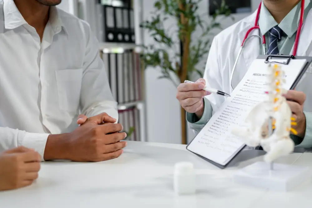 Doctor at a desk going over paperwork with a patient